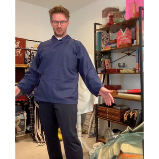 Model wearing a navy blue Chore Jacket Sewing Pattern, showcasing the Japanese Samue style in a casual setting.