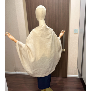 Back view of a Cape Jacket Sewing Pattern displayed on a mannequin, showcasing its stylish and versatile design.