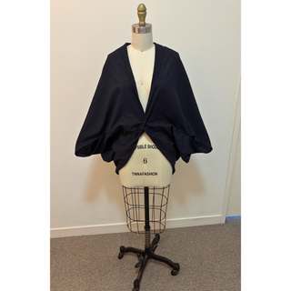 Cape Jacket Sewing Pattern displayed on a dress form, showcasing a stylish black cape jacket design.