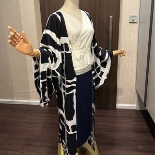 Kimono Coat Sewing Pattern displayed on a mannequin, featuring a black and white design and flowing sleeves.