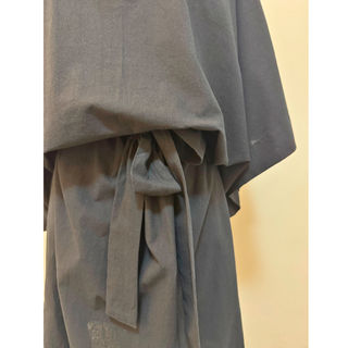 Close-up of the tie waist and wide sleeves of a Kimono Dress Sewing Pattern in a solid gray fabric.