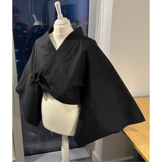 Black kimono jacket displayed on a mannequin, showcasing the fashionable style of the Kimono Jacket Sewing Pattern.