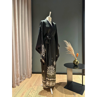 Elegant black lined kimono sewing pattern displayed on a mannequin against a chic background.