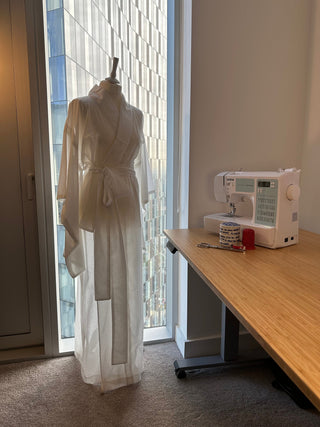Kimono Sewing Pattern displayed on a mannequin next to a sewing machine and a crafting workspace.